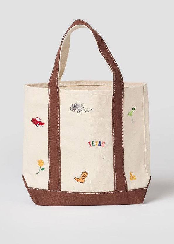 Tote bag with embroidered designs on a white background